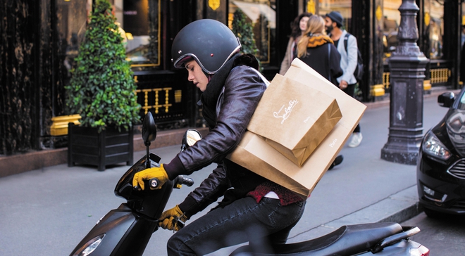 Кристен Стюарт на мотопед, с каска и покупки на рамо