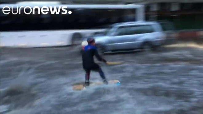 Russians wakeboard in Moscow street after torrential rain.