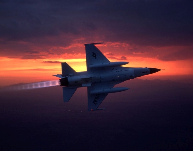Изтребител F-16 в полет по залез слънце